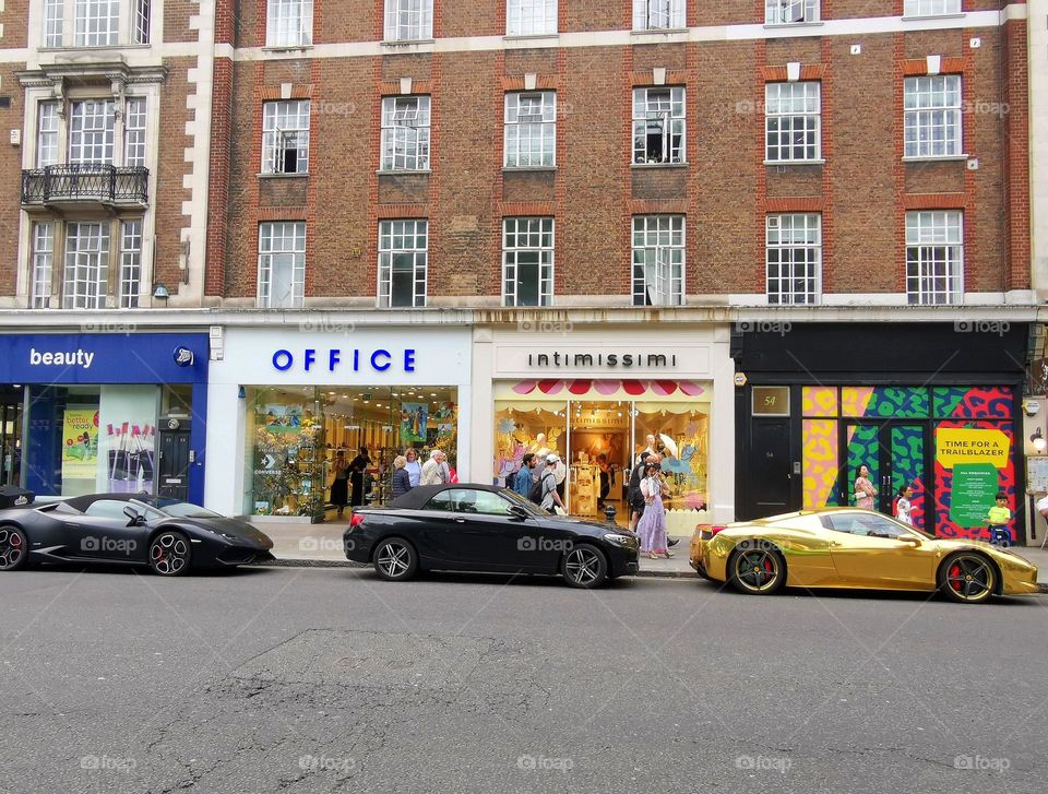 Street photo. London, Chelsea. Expensive brands of cars parked on the streets of the city. Ferrari, Lamborghini, BMW.