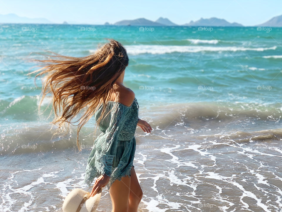 Young woman with long hair on tropical beach 