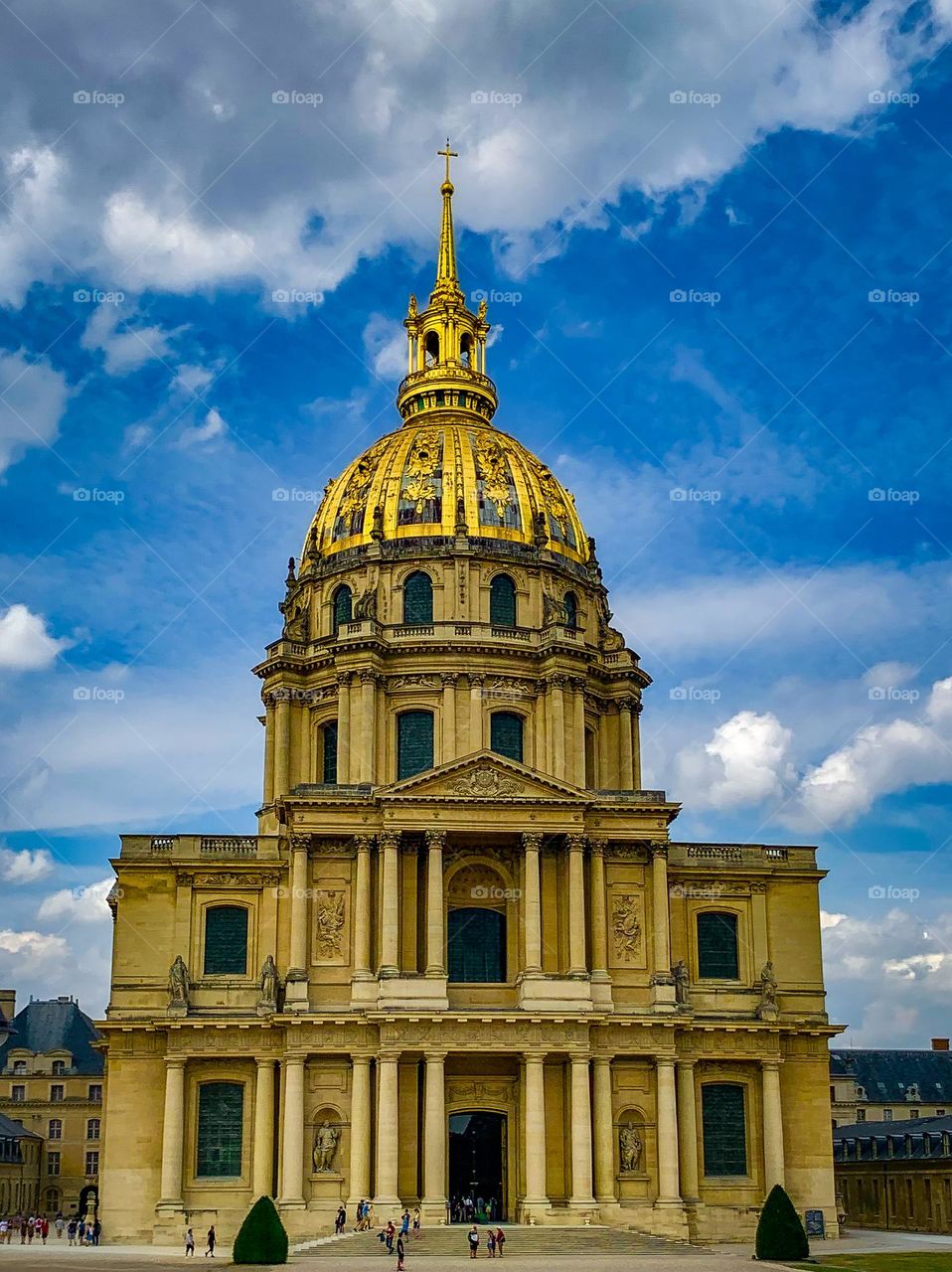 A daytime photo of the Tomb of Napoleon Bonaparte. Hôtel des Invalides, Paris, France. Prominent clouds in the background.