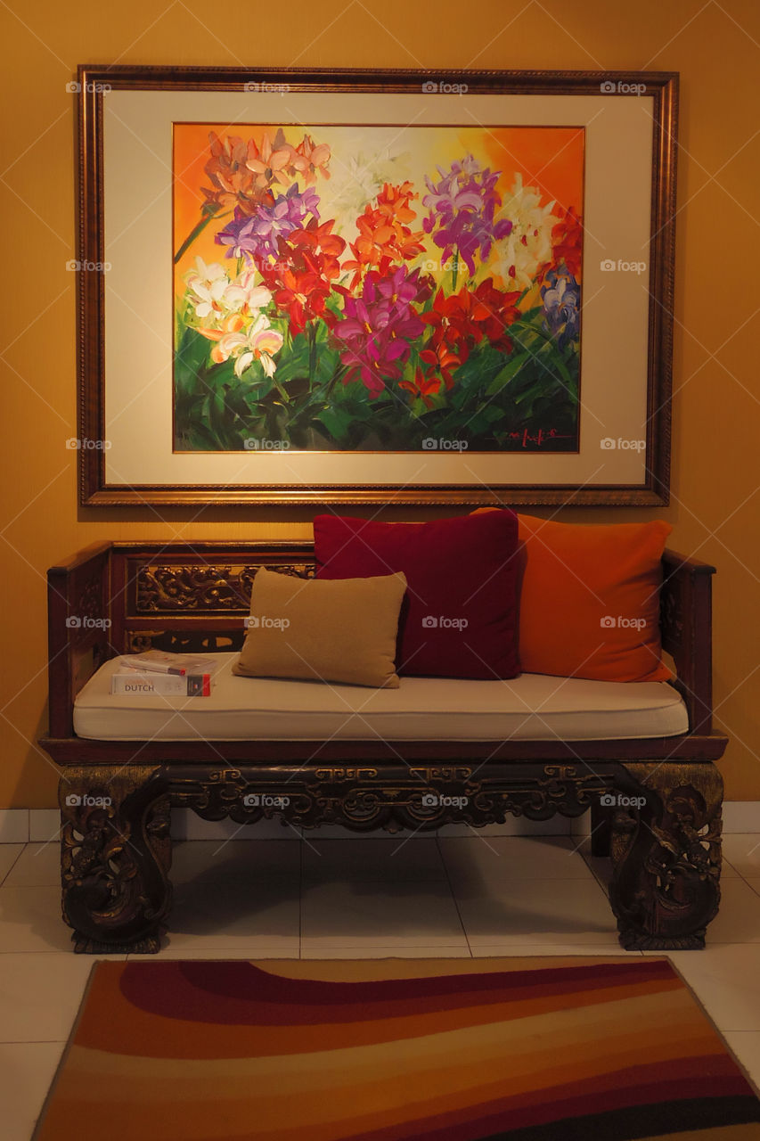 wooden sofa and wall painting
