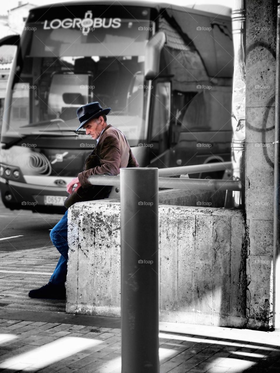 Man waiting for a bus in the city, portrait of a city, man waiting in the city, colors in black and white photo, background of black and white, old man waits, elderly man waiting in the city