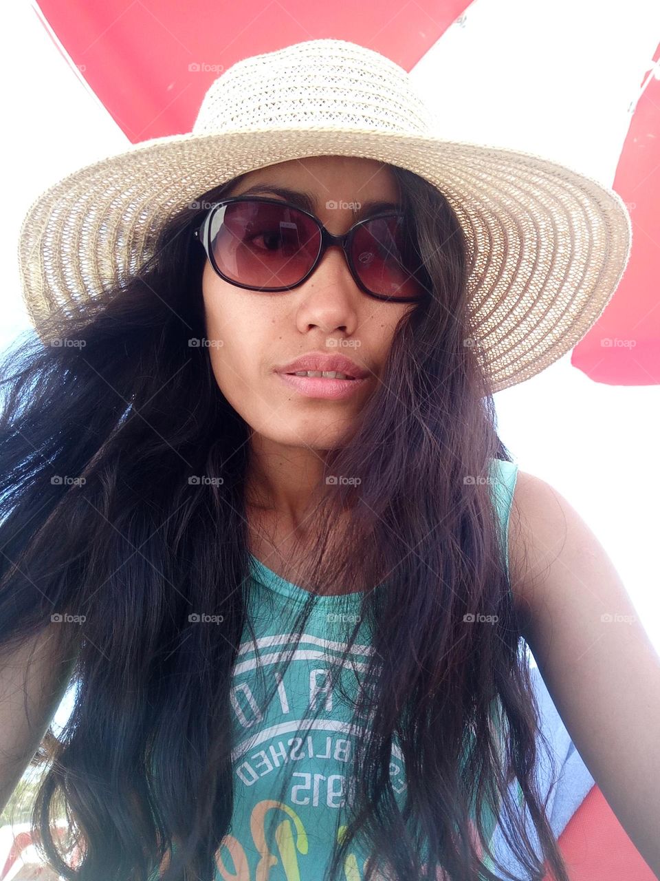 A woman under the beach umbrella 