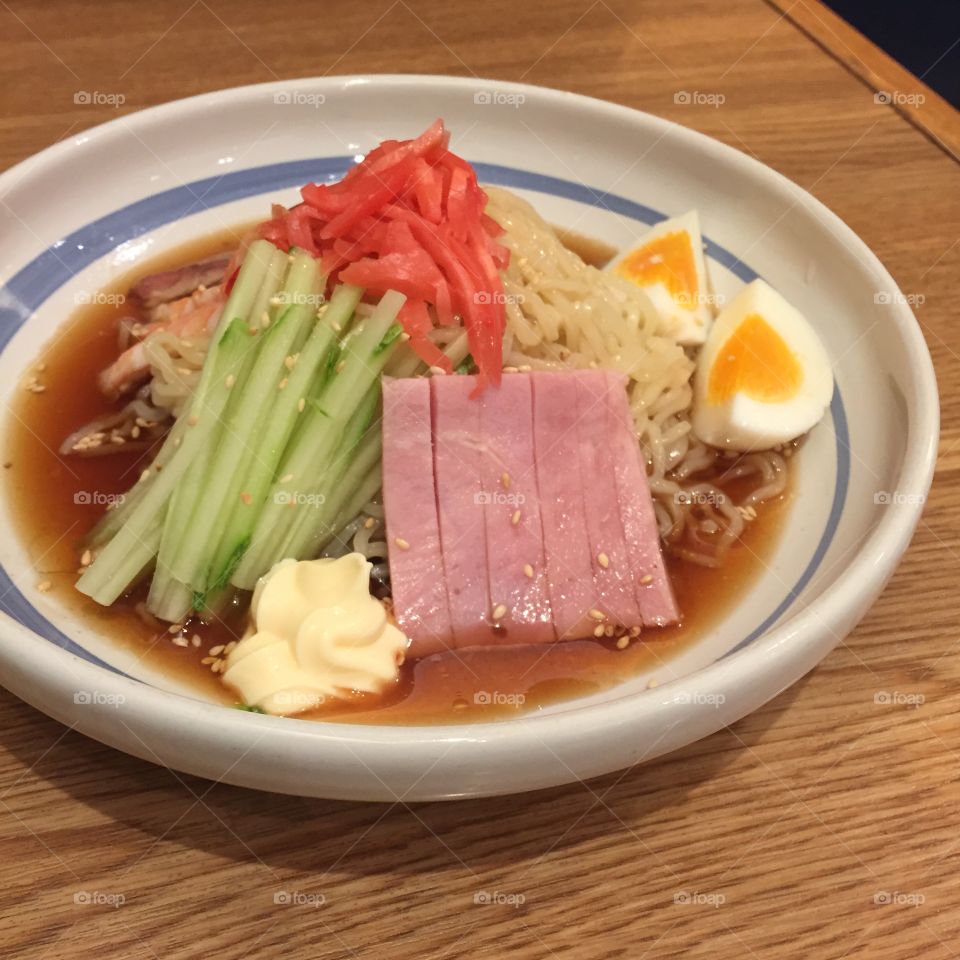 Cold ramen with shrimp, Japanese roast pork, ham, egg and cucumber in lemon sauce garnished with mayonnaise and pickled ginger great for any use.
