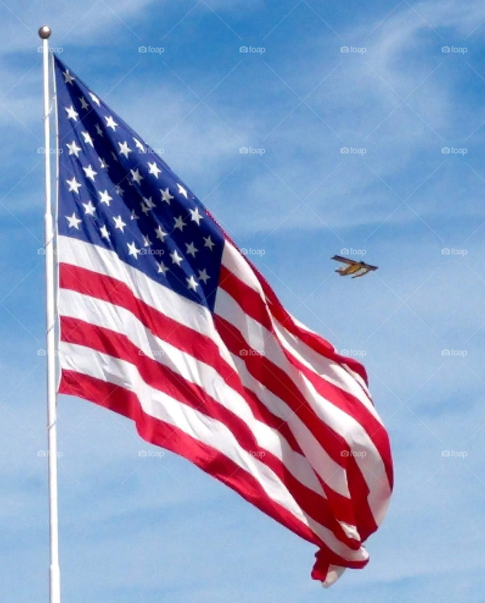 Flag with airplane in background in Calera, AL