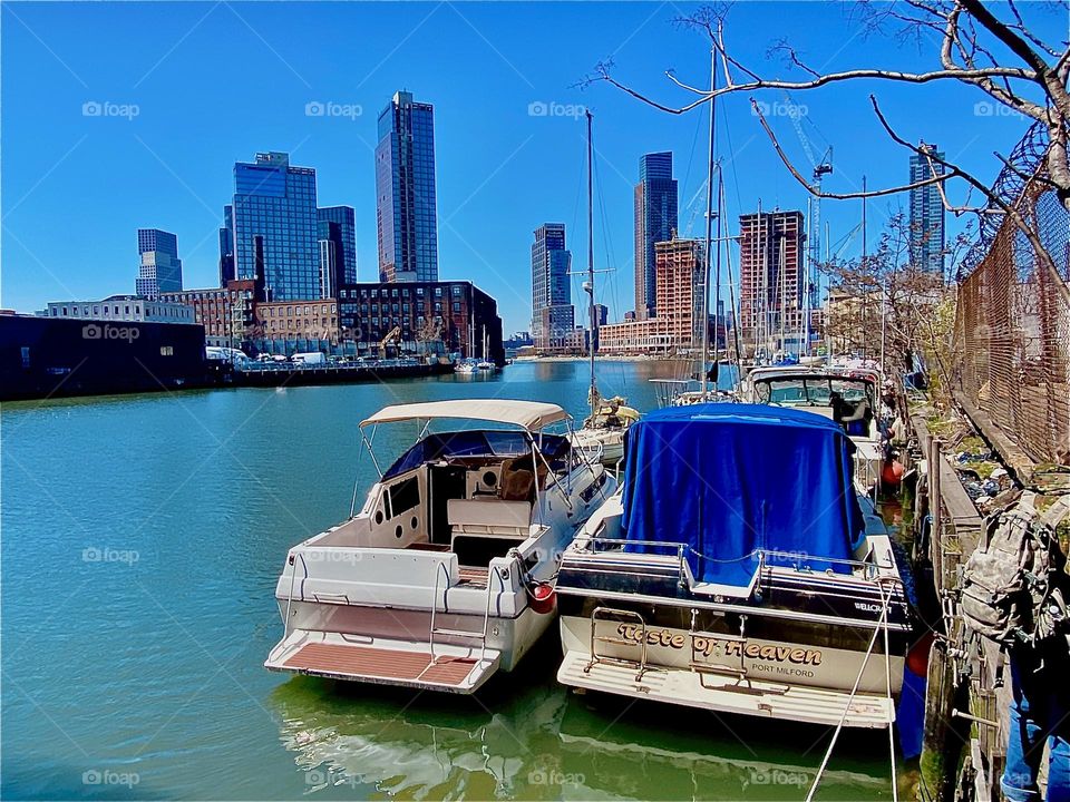 Amazingly bright colors can be seen here at “Newtown Creek” by the “Pulaski Bridge” in “Long Island City”, Queens today and the ocean’s surface is still, smooth and shiny. 2023. Hypnotic Productions