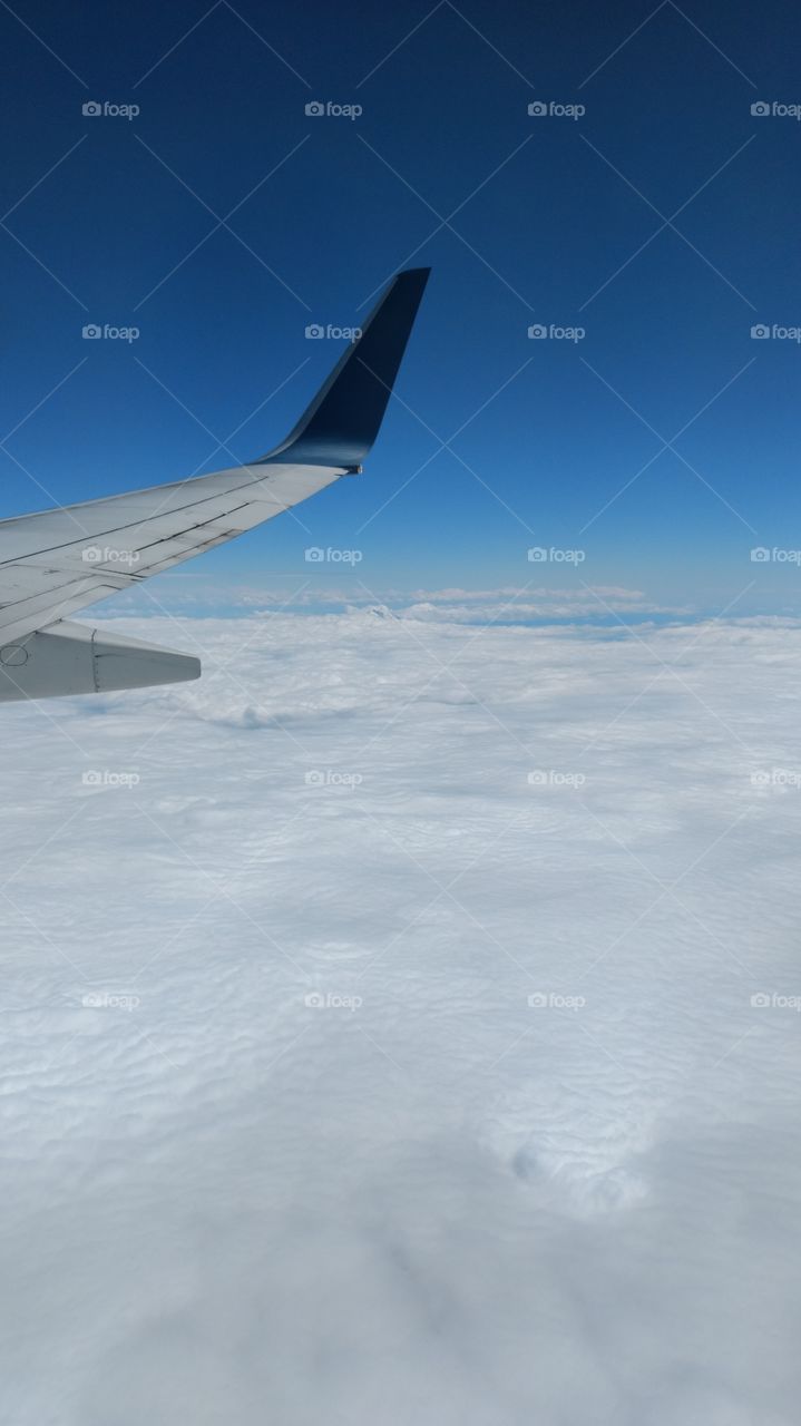 Flying over cloud covered mountain