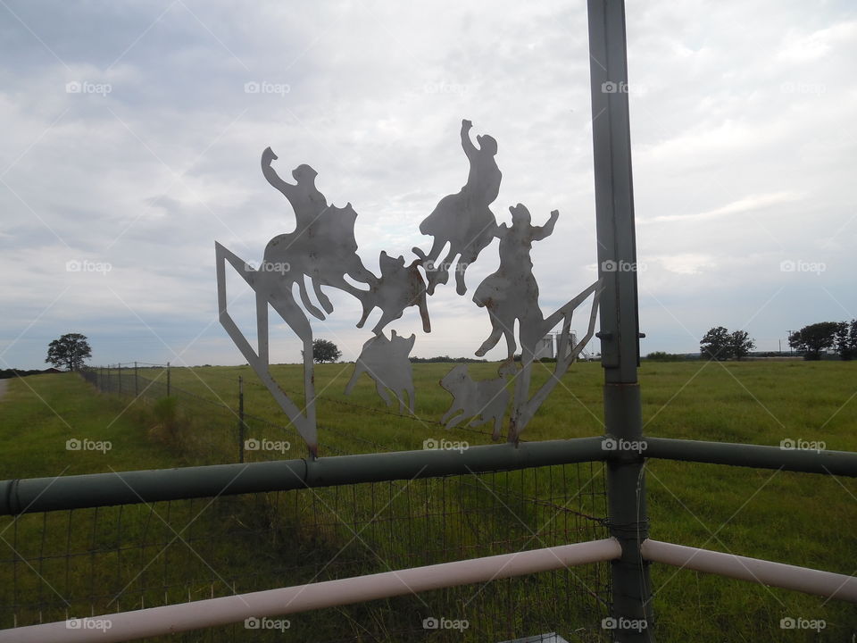 ride em cowboy. This is a picture of a sign made out of sheet metal. 👣 🚶 🏃 🔥 💨