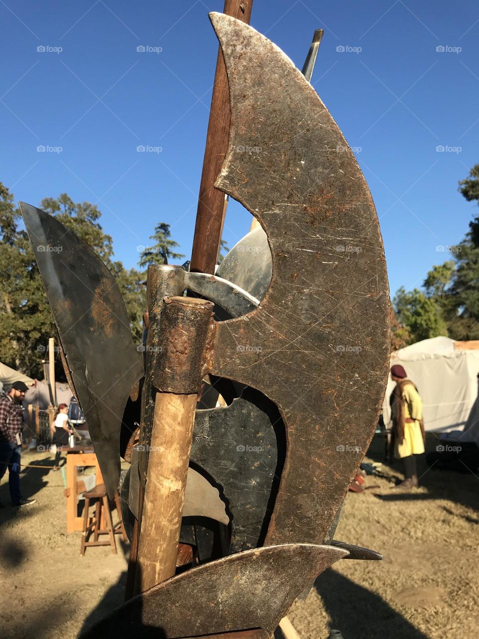 Bladed arms on a display rack at the encampment of an Irish re-enactment guild during the Kearney Park Renaissance Faire.