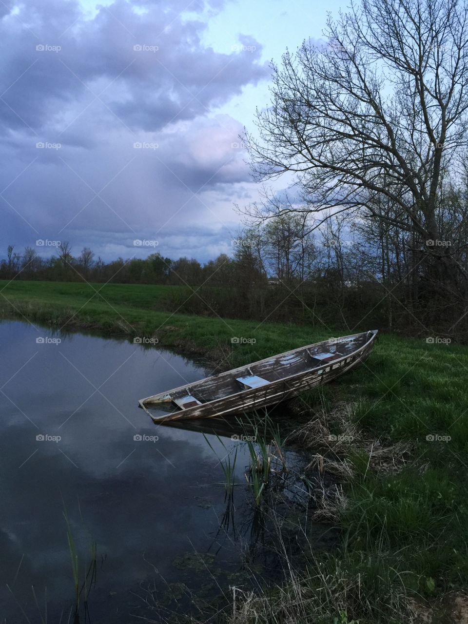 Weathered boat in lake
