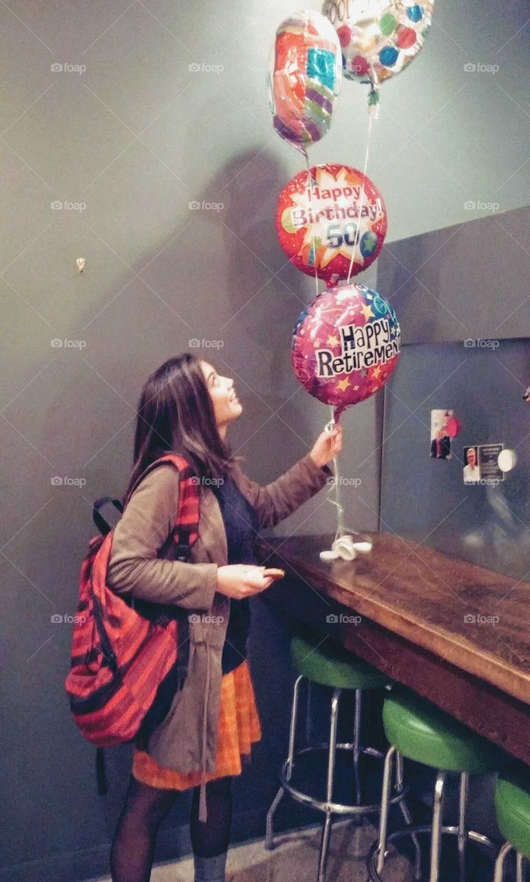 Girl Holds Balloons