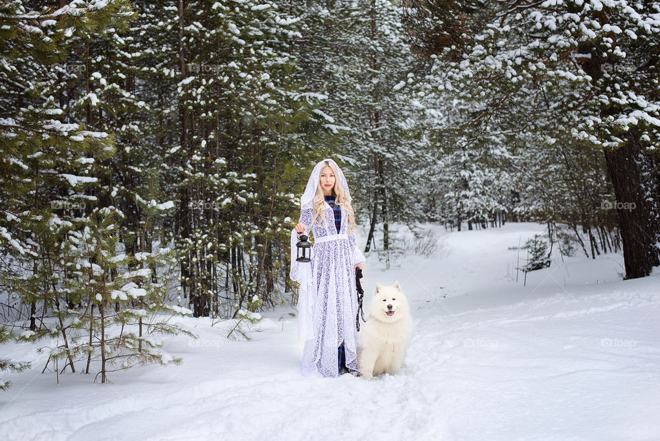 Woman with white dog in winter