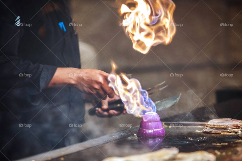 chef preparing onion on grill