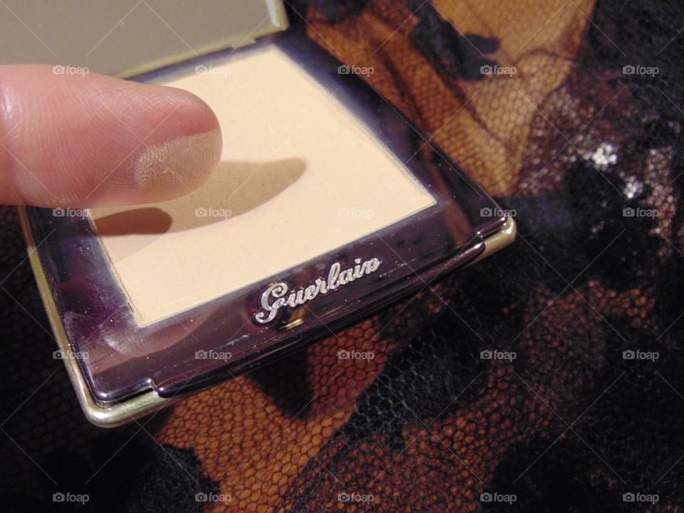 Testing Guerlain powder on a finger 