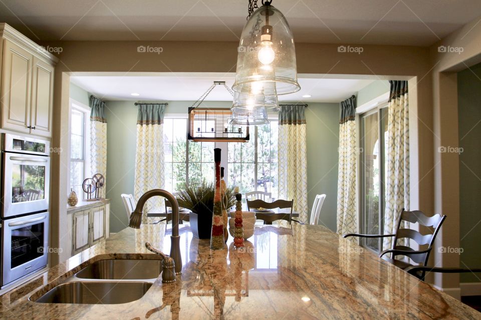 Open space kitchen with a wide center island and lots of natural light coming from large windows