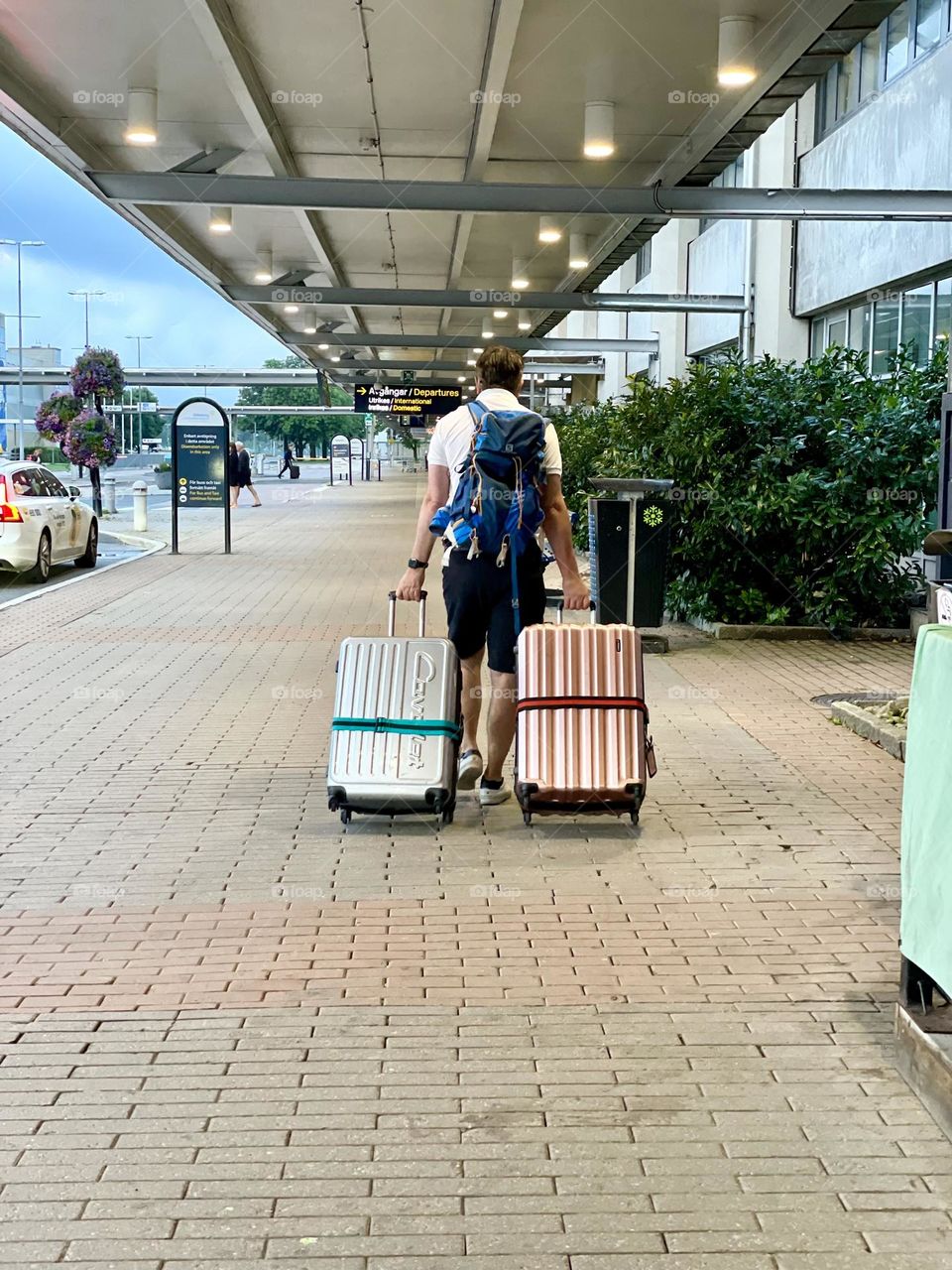 Man with luggage outside the airport heading for vacation 