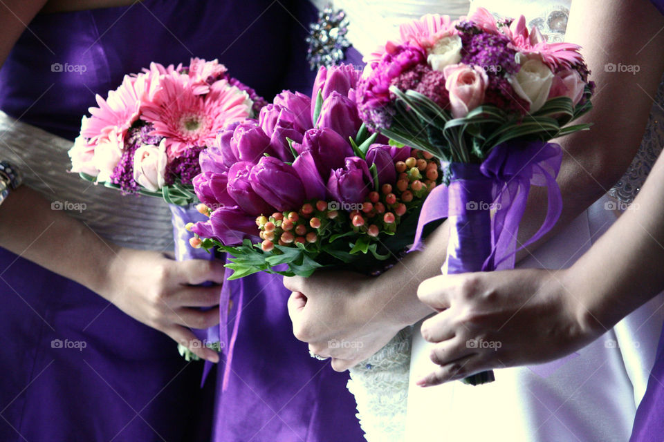 hands of brides maid with bouquetof flowers