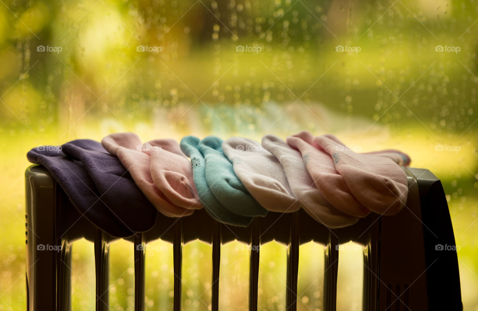 socks on a heater in a cold rainy day