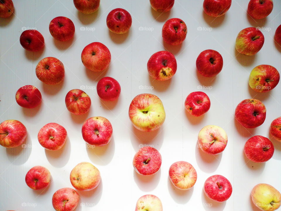 a lot of red apples on a white background