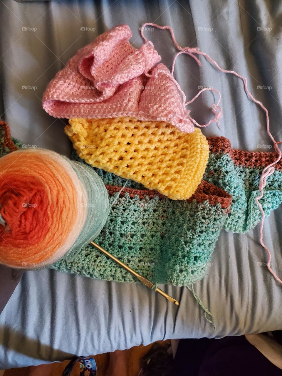 multiple colorful crochet projects that have been started