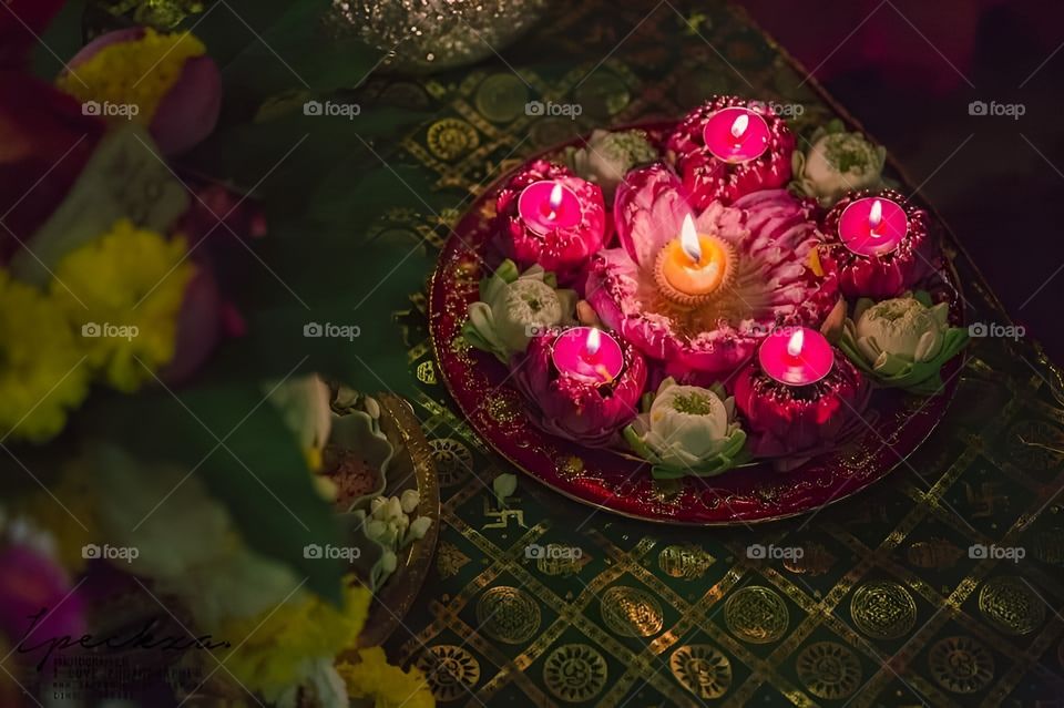 Lotus flowers and candles in the ritual offering