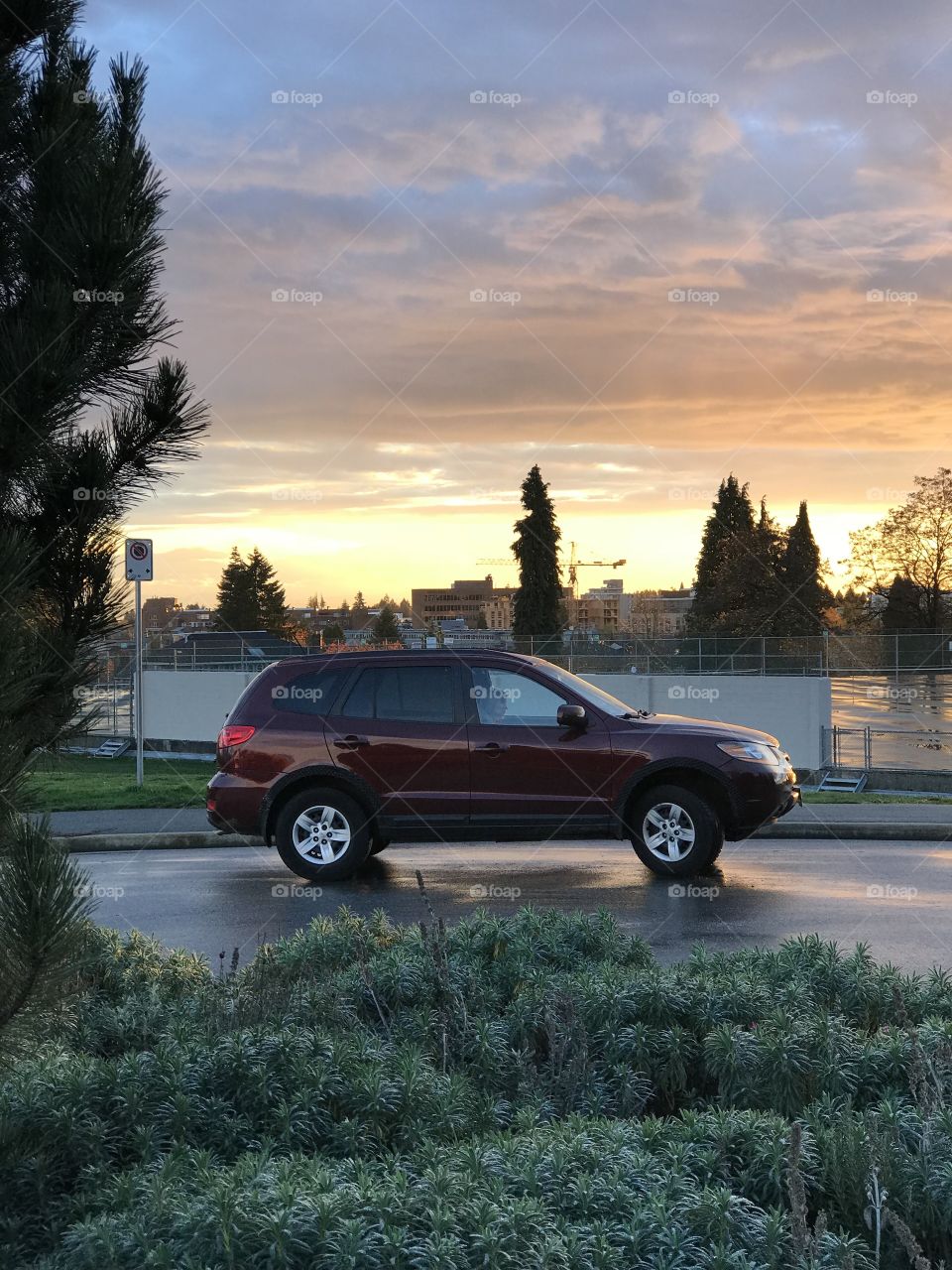 Car overlooking tennis courts at sunset 