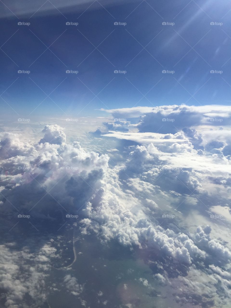 Billowy white cloud formations in the sky, view from airplane 