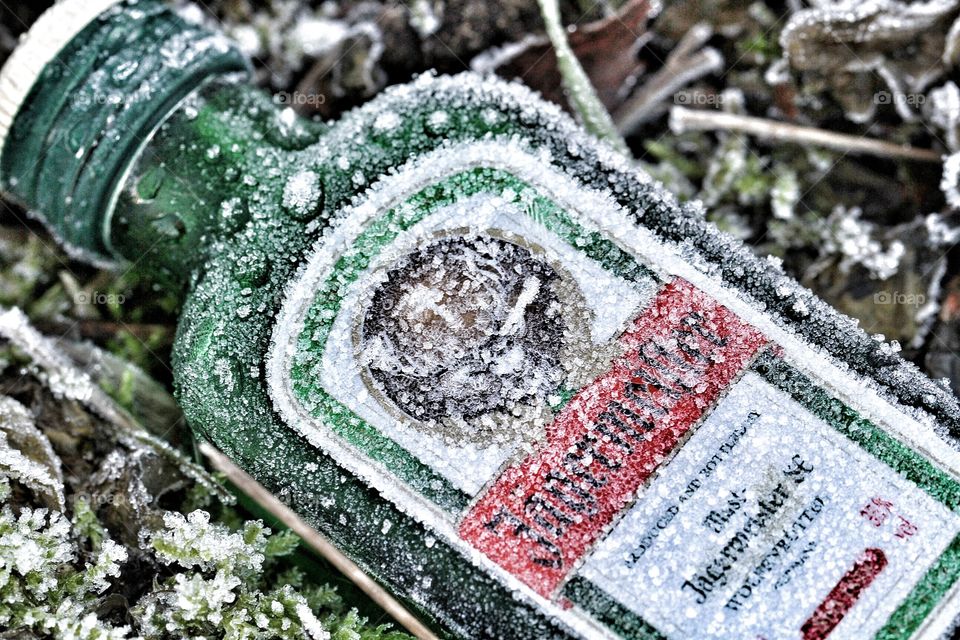 A frozen Jaegermeister bottle covered in frost and ice. 