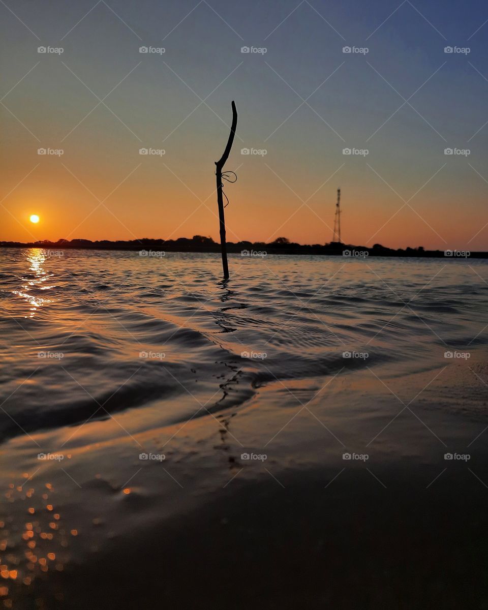 Beautiful sunset, reflection on the lagoon, breathtaking colours at paradise beach Chalai, Sri Lanka