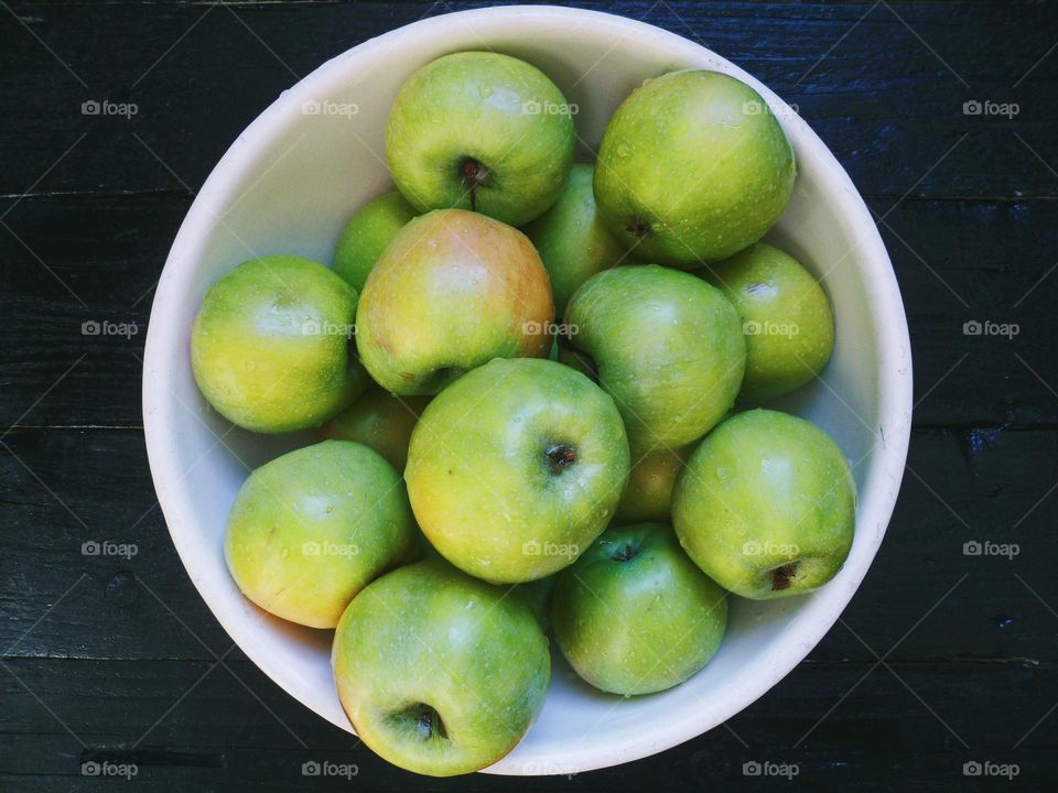 green apples in a white bowl