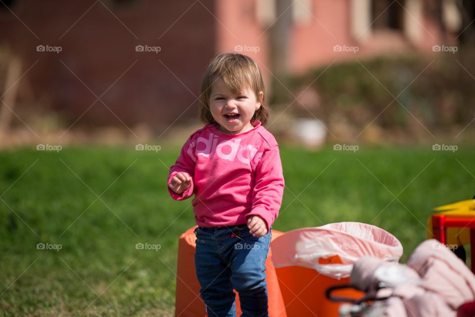 baby girl laughing outdoors