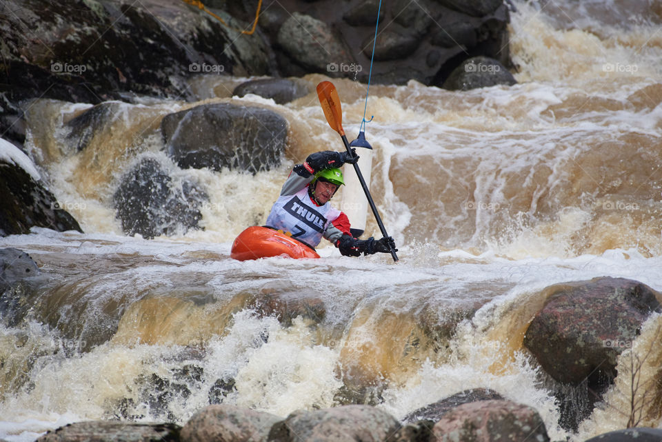 Helsinki, Finland -  April 15, 2018: Unidentified racer at the annual Icebreak 2018 whitewater kayaking competition at the Vanhankaupunginkoski rapids in Helsinki, Finland.