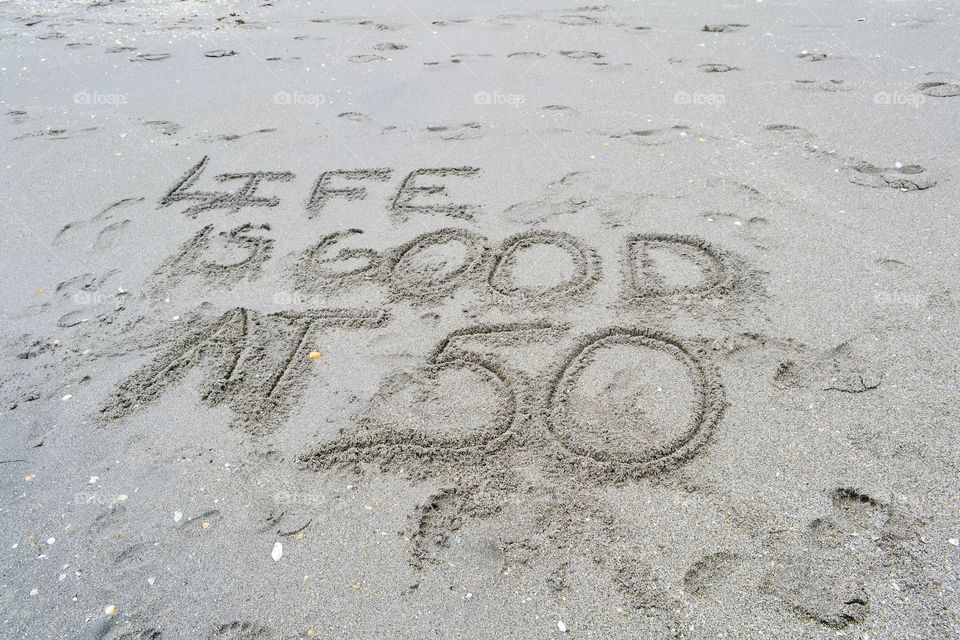 Life is Good at 50. It's written in the sand: Life is Good at 50