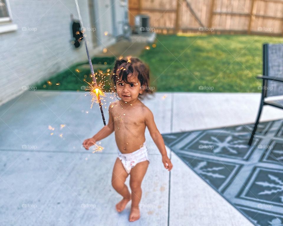 Fourth of July celebration with sparklers, backyard celebration of 4th of July, American baby with sparklers, fireworks on 4th of July, celebrating America, Americans celebrate the United States