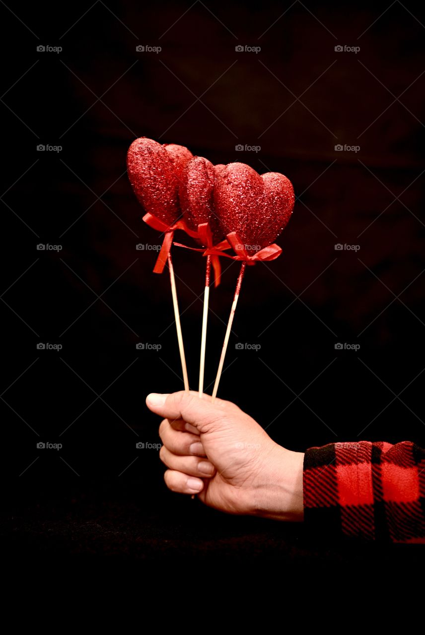 Close up shot of three hearts for a special person with the black background “for you”