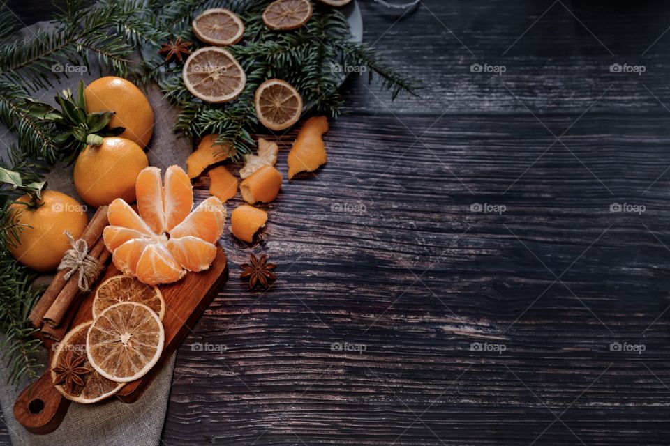 Flatlay mandarin orange cinnamon and Christmas tree branches 