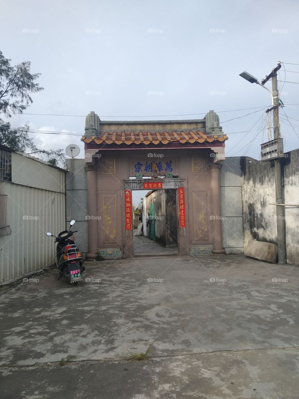 The archway of Chinese traditional architectural design style, the couplet on the threshold is the work I wrote for the village duty