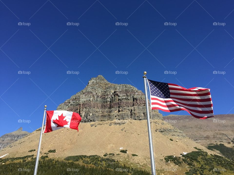 The US and Canadian Flags in Glacier National Park