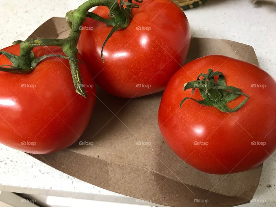 A trio of red tomatoes