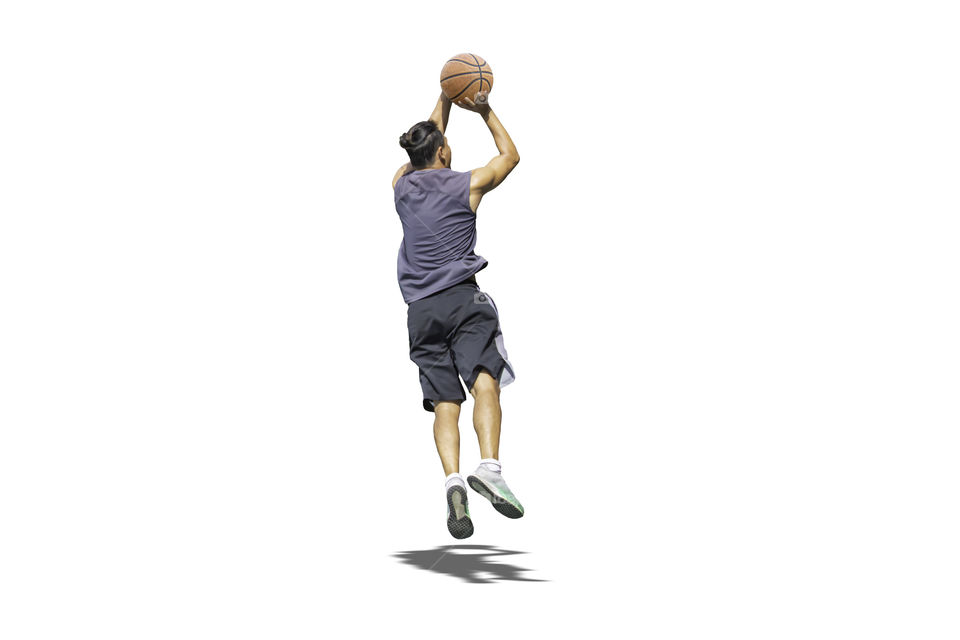 Isolated Basketball in hand man jumping on a white background with clipping path...