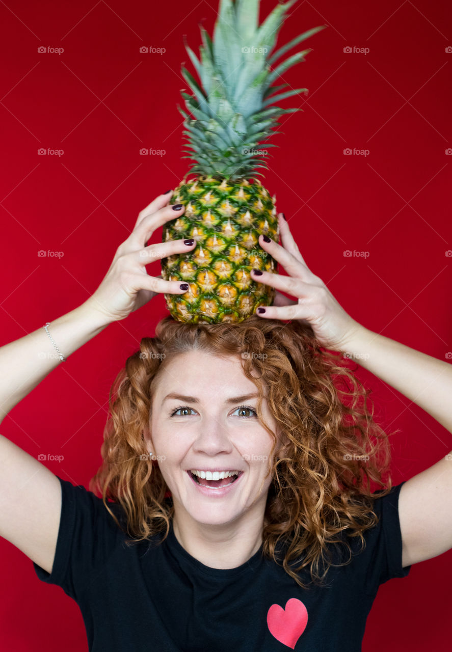 beautiful red-haired girl with pineapple with cool emotions