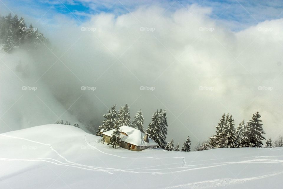 Picturesque house in the French Alps- everything covered in snow