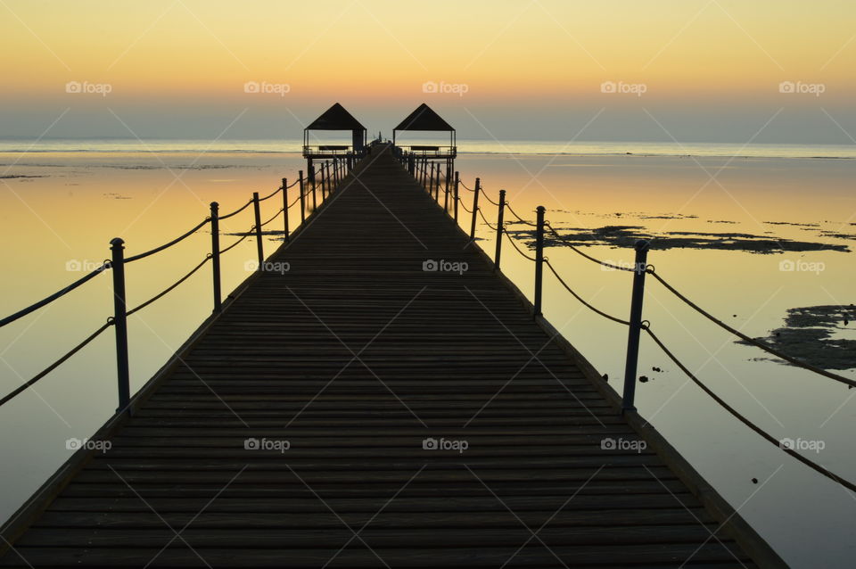 Romantic walk waiting for the sun to rise over the ocean