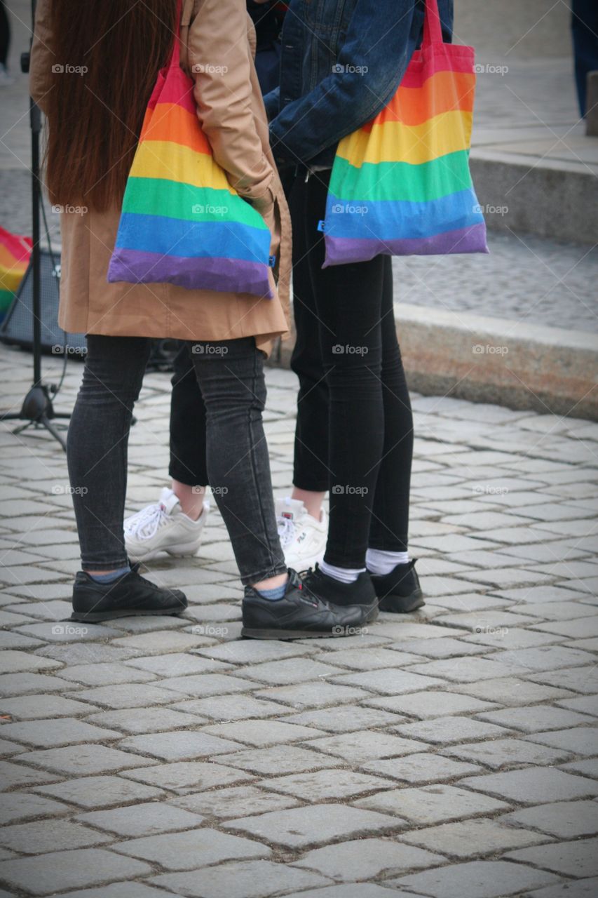 Girls with rainbow bags.