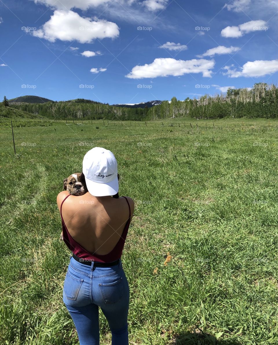 A girl and her puppy in the mountains