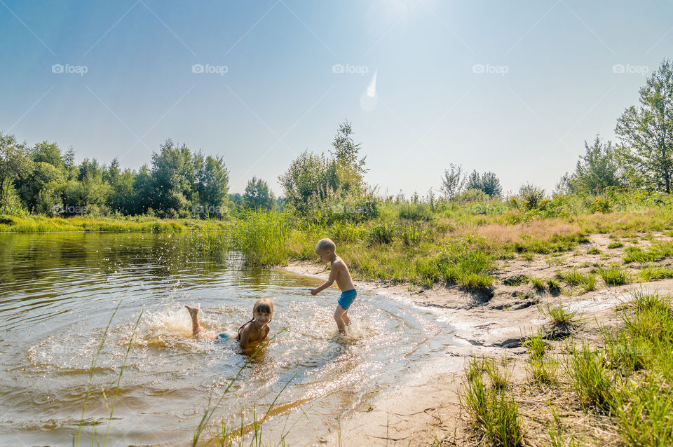 Kids swimming on the lake, sunny day