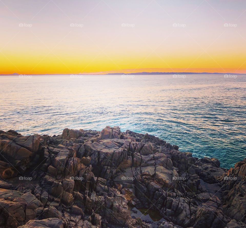 Sunset over the sea from the rocks