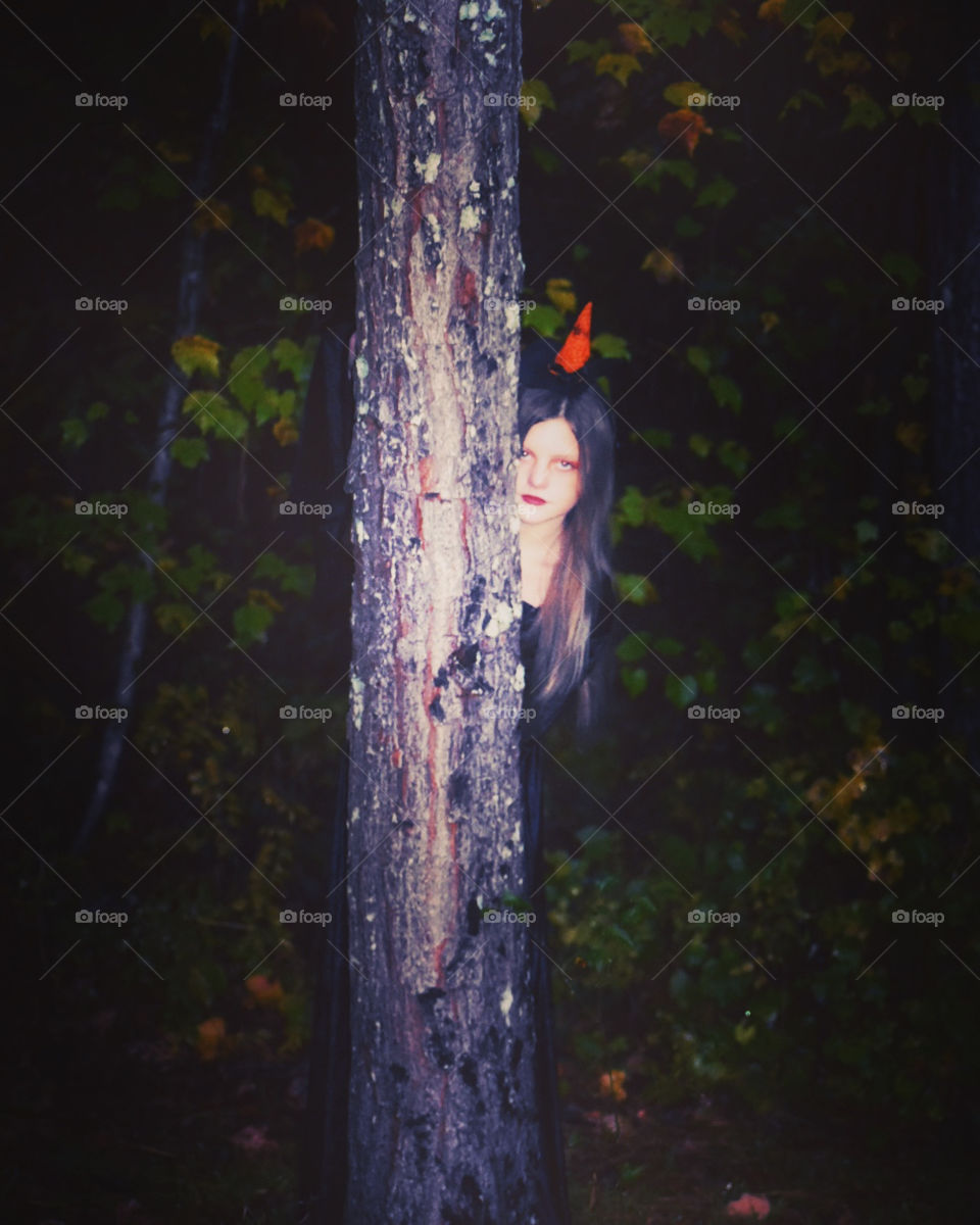 Witchy vibes from our little girl, peeking from behind the woods. 