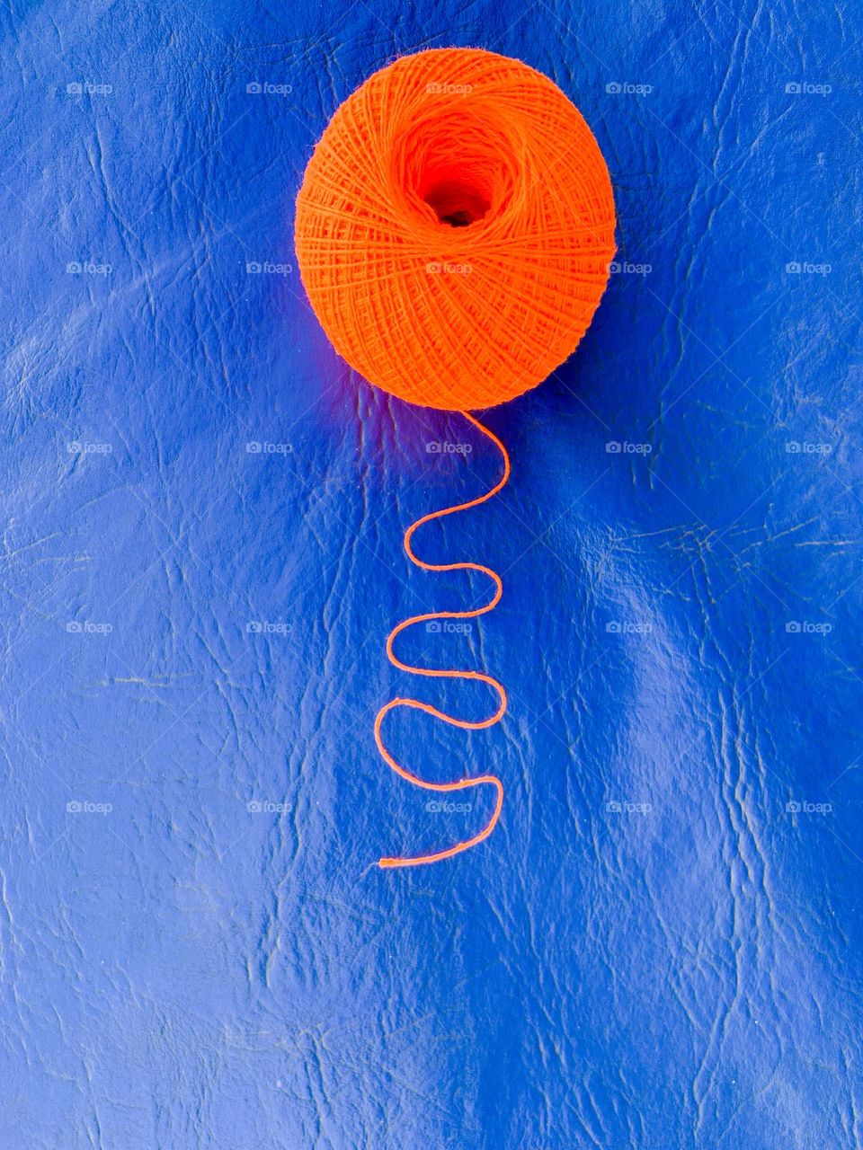 Orange cotton ball in blue background 