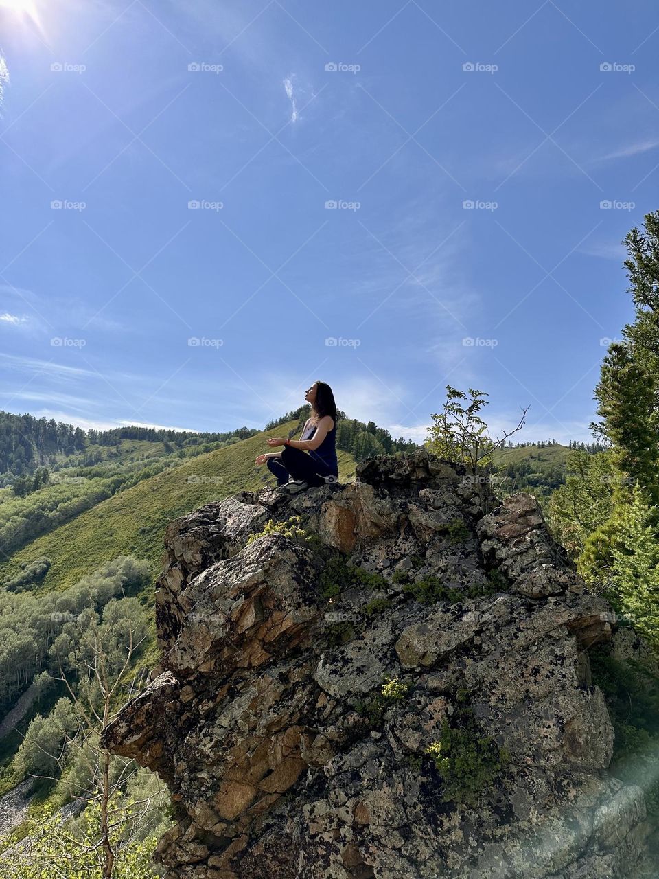 girl meditating on a rock