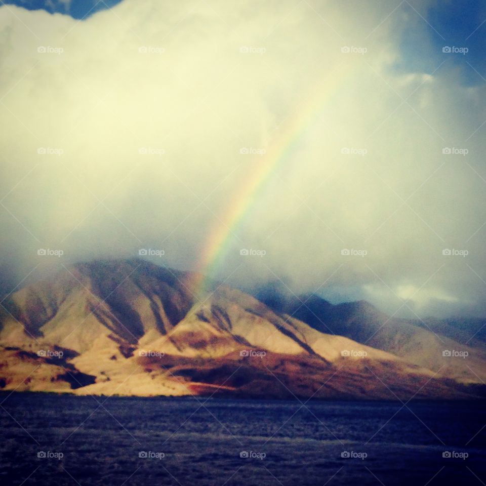 Rainbow at sunset. Rainbow just at the golden hour in Maui